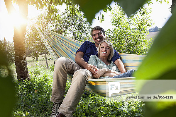 Relaxed mature couple in hammock