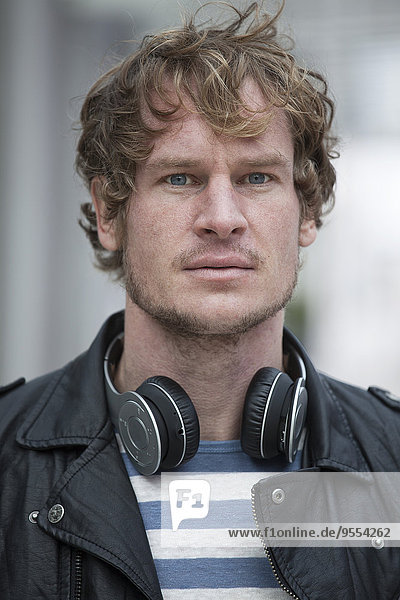 Portrait of serious looking man with headphones