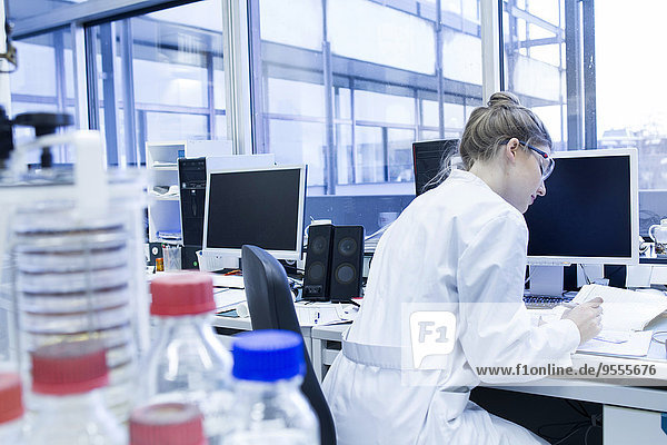 Biologist working in laboratory at desk