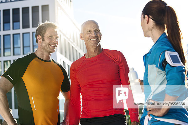 Three athletic people outdoors
