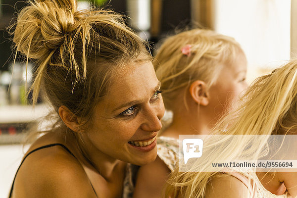 Happy mother with two girls looking out