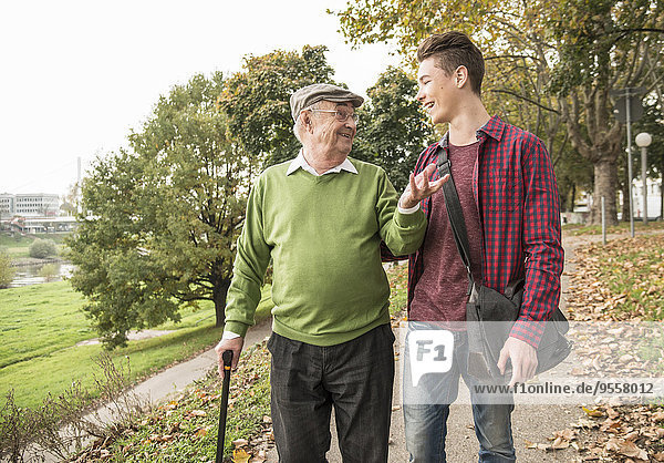 Senior man and adult grandson in park