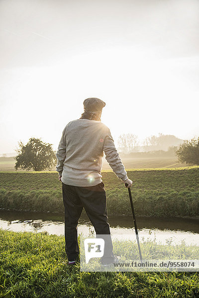 Senior man standing in rural landscape