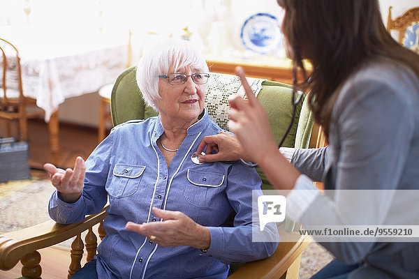 Medic caring for senior woman at home