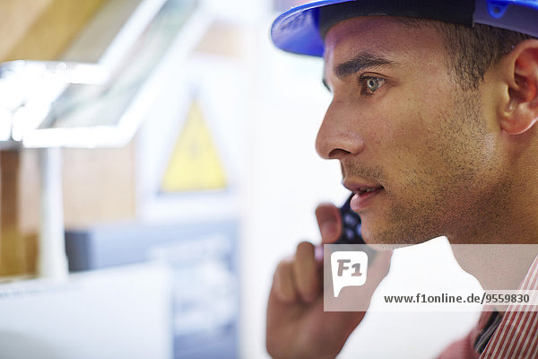 Man with hard hat on cell phone