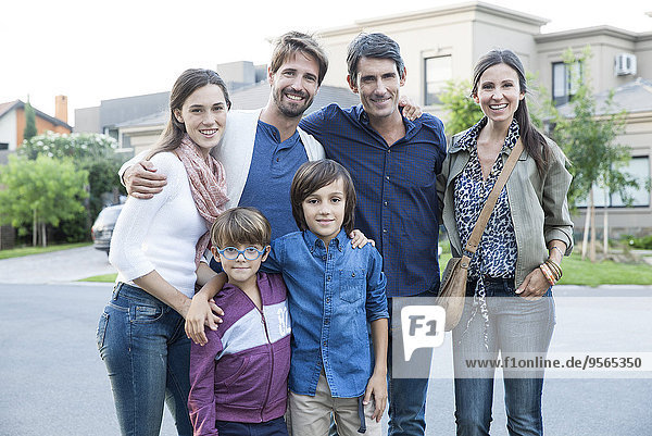 Family posing together on suburban street  portrait