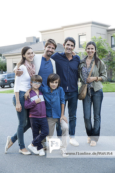 Family posing together on suburban street  portrait