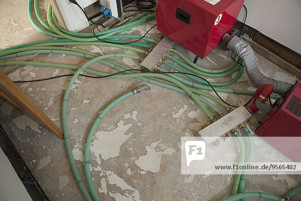 High angle view of tubes and machines in room under renovation