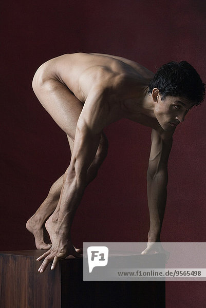 Nude man crouching in starting position  full length