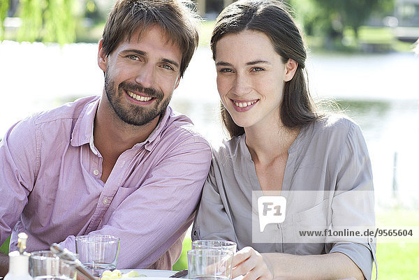 Couple enjoying picnic with family