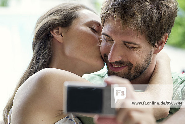 Couple kissing and taking selfie