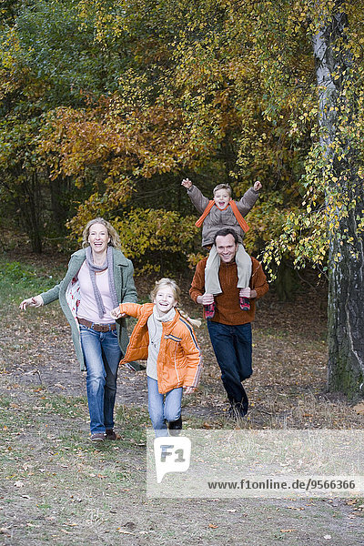 Family in park together in autumn