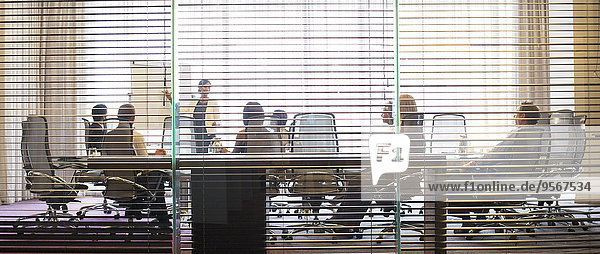 Business people watching presentation in conference room