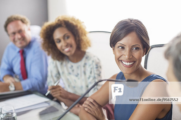 Portrait of smiling woman sitting at conference table