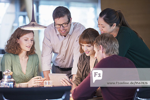 Business people using digital tablet in office meeting