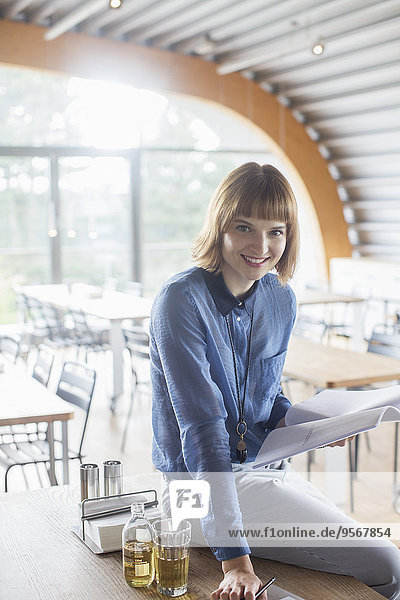 Businesswoman smiling in cafeteria