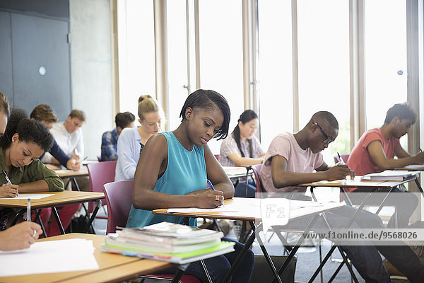 University students taking exam at classroom