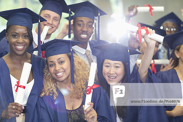 Portrait of university students standing in corridor after graduation ceremony