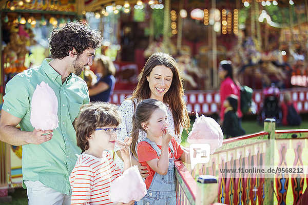 Familie mit rosa Zuckerwatte im Vergnügungspark