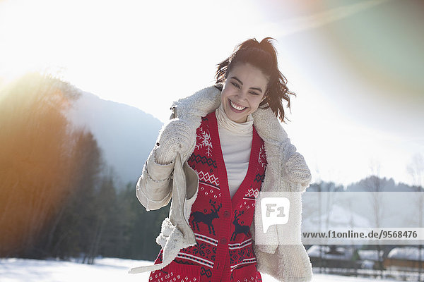 Smiling woman in snowy field