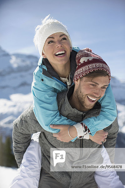 Couple piggybacking in snow