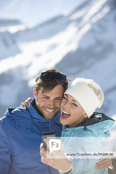 Couple taking selfie in snow