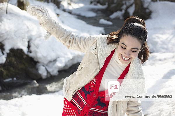 Happy woman playing in snow