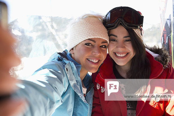 Friends in ski lift taking selfie
