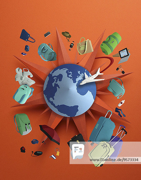 Globus  Kompass und Flugzeug umgeben von Gepäck und Zubehör