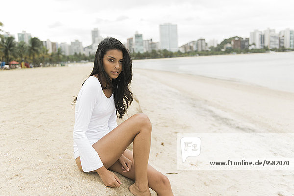 Woman sitting on urban beach