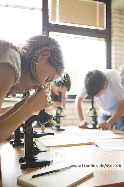 Students using microscopes in science class
