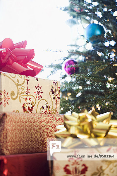 Close up of wrapped gifts under Christmas tree