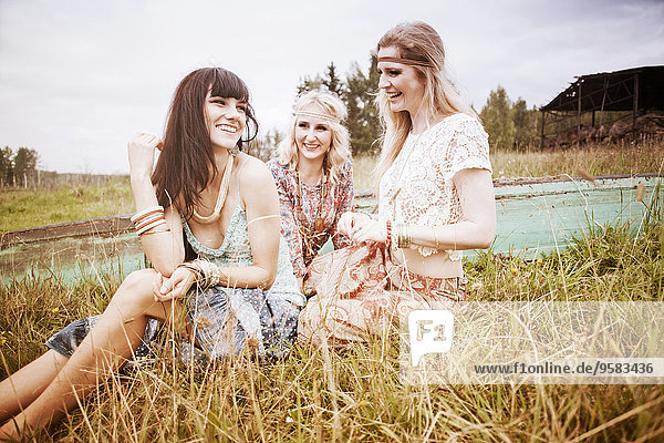 Caucasian women laughing in field