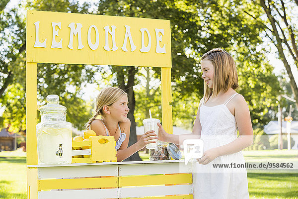 Caucasian girl buying drink at lemonade stand