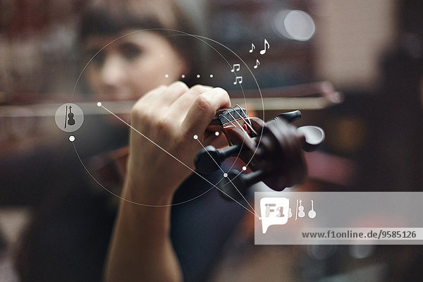 Caucasian woman playing violin overlaid with graphic design