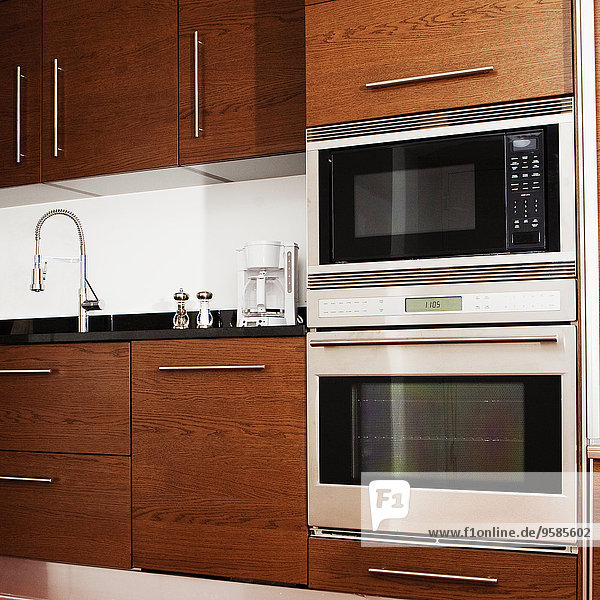 Oven  microwave  cabinets and sink in modern kitchen