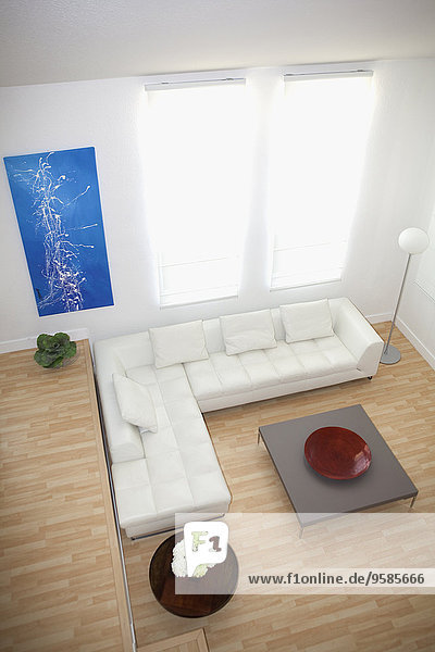 High angle view of sofas and coffee table in modern living room