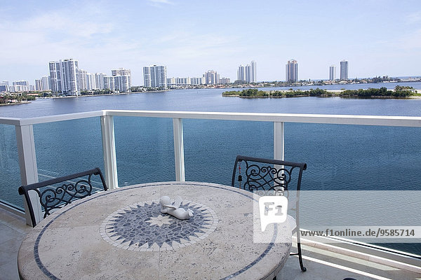 Table and chairs on balcony overlooking city skyline  Miami  Florida  United States