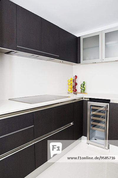 Cabinets  stove and miniature refrigerator in modern kitchen