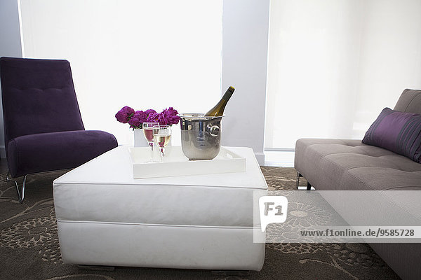 Champagne on coffee table in modern living room