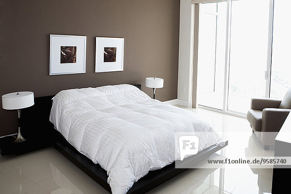 Bed  wall art and windows in modern bedroom