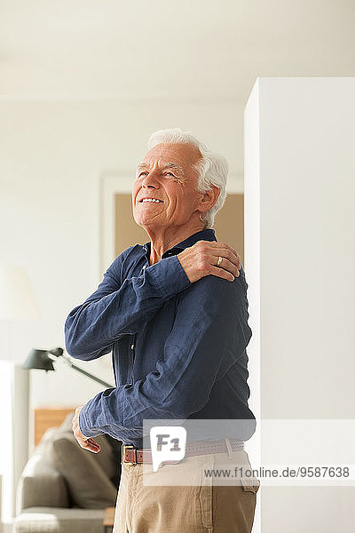 Portrait of senior man feeling pain in his shoulder