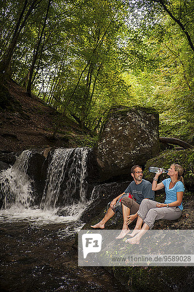 Germany  Rhineland-Palatinate  Moselsteig  Ehrbachklamm  couple resting at waterfall