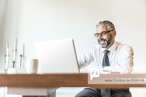 Portrait of smiling businessman working at home office