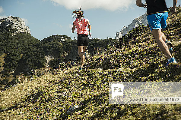 Austria  Tyrol  Tannheim Valley  young couple jogging in mountains