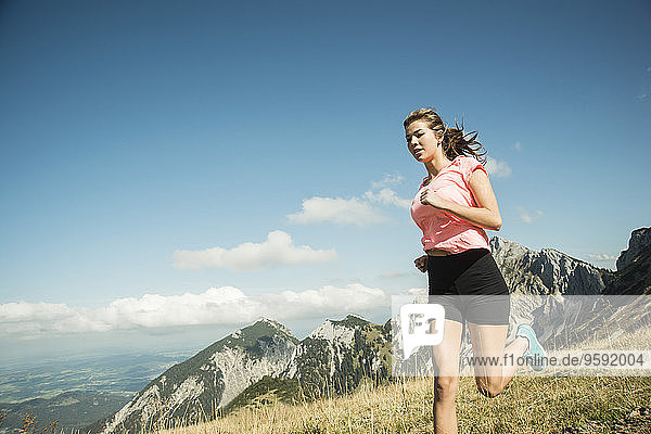 Austria  Tyrol  Tannheim Valley  young woman jogging in mountains