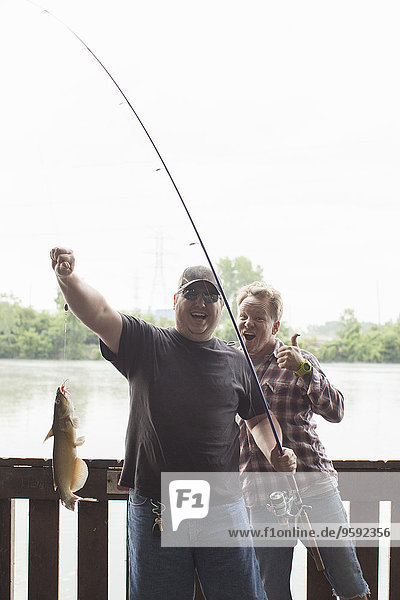 Two fishermen with catfish  river Raisin  Monroe  Michigan  USA