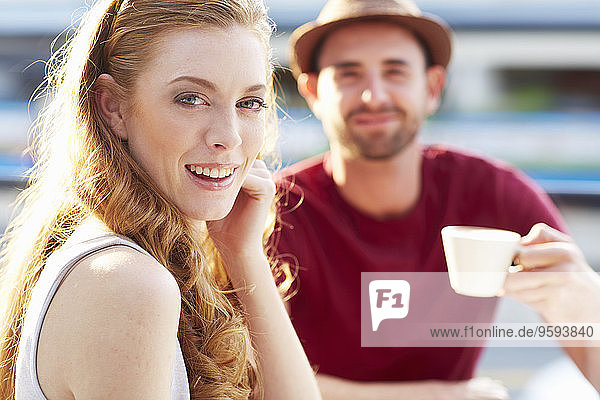 Portrait of smiling young woman having a coffee break with her boyfriend