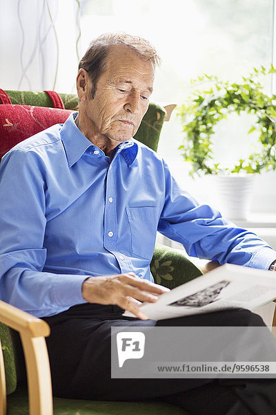 Senior man reading book at nursing home