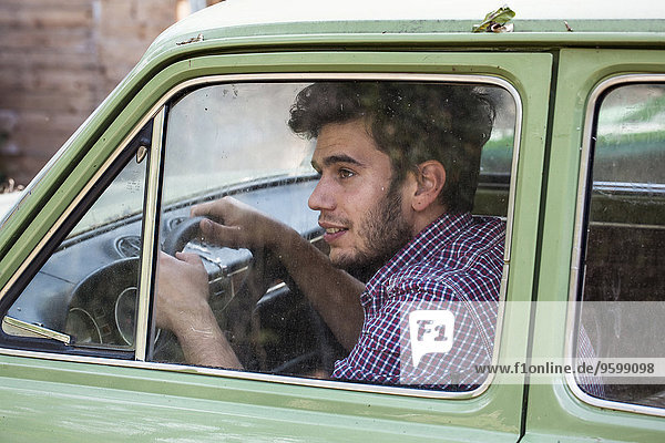 Young male farmer looking out of car window  Premosello  Verbania  Piemonte  Italy